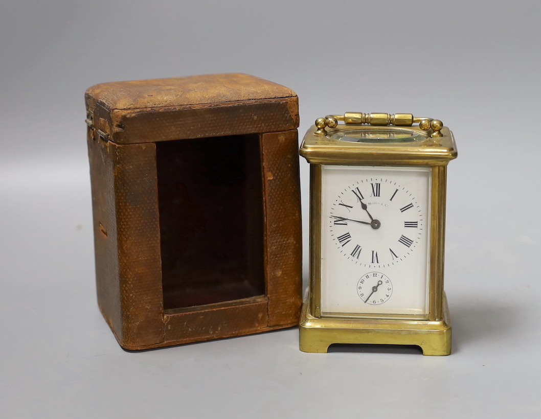 A brass carriage timepiece, retailed by J. Moser & co. in leather case with key.